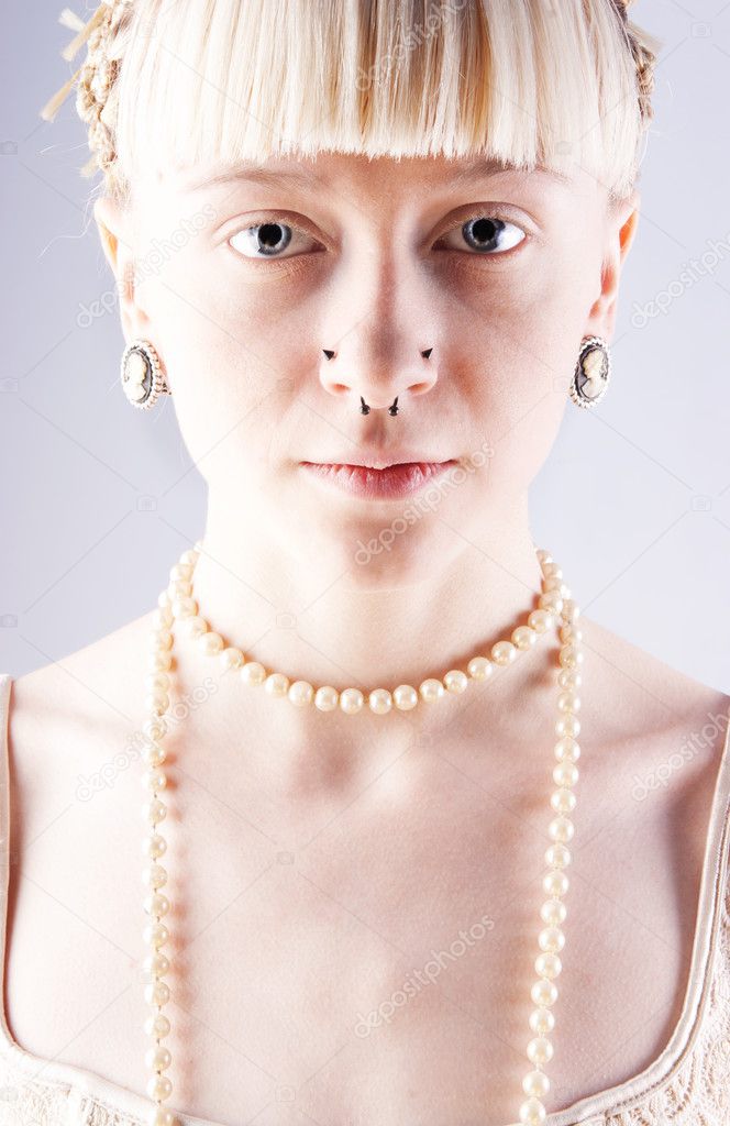 Beautiful blonde girl with a pearl on her neck