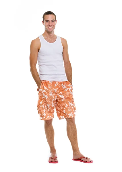 Full length portrait of on vacation smiling young man in shorts — Stock Photo, Image