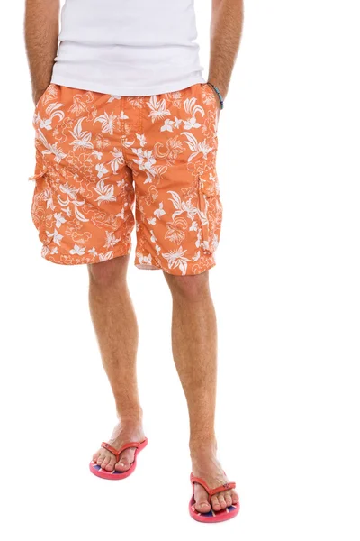Closeup on legs of male in shorts and flip flops — Stock Photo, Image