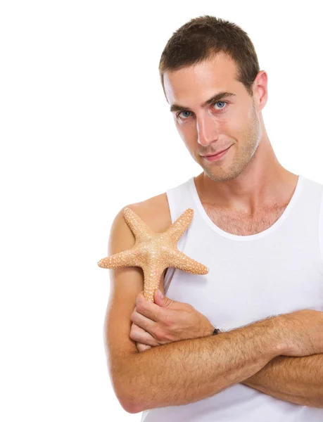 Portrait of on vacation young man with sea star — Stock Photo, Image