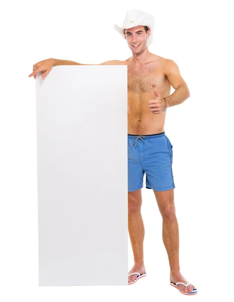 Sorrindo homem de chapéu mostrando cartaz em branco e polegares para cima — Fotografia de Stock