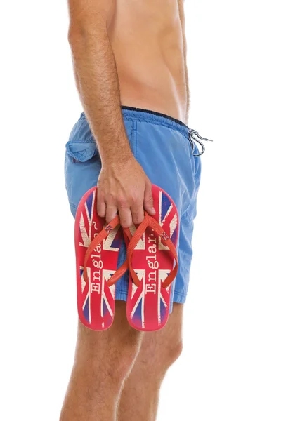 Close-up na mão de masculino segurando chinelos estilo Inglaterra — Fotografia de Stock