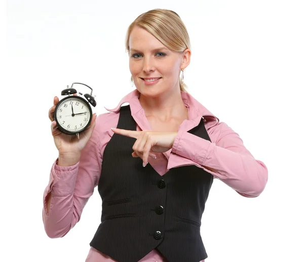 Woman employee pointing on alarm clock — Stock Photo, Image