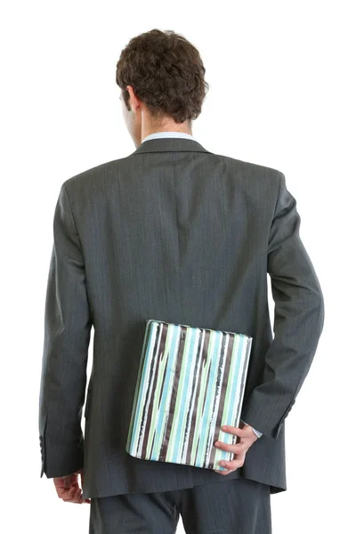 Modern businessman standing back to camera and holding gift box — Stock Photo, Image