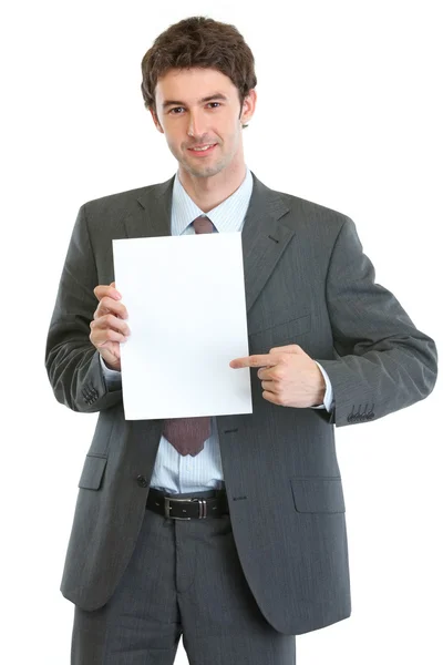 Modern businessman pointing on blank paper sheet — Stock Photo, Image