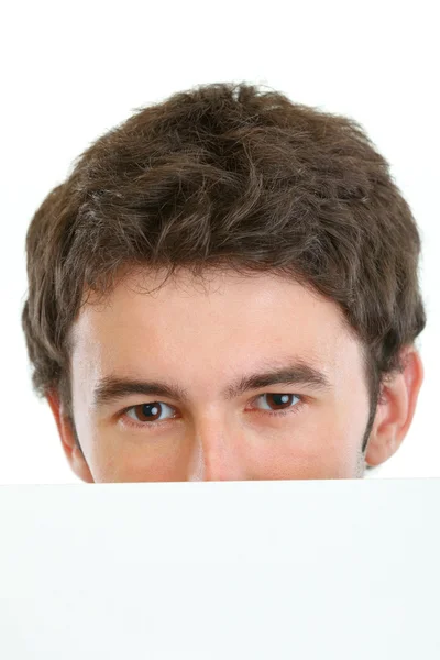 Man hiding behind blank billboard — Stock Photo, Image