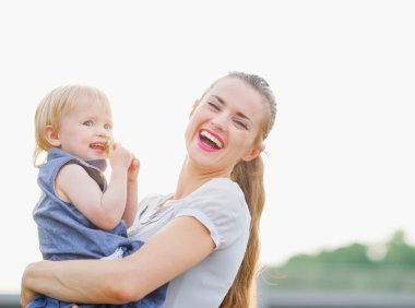 Portrait of happy mother with baby clipart