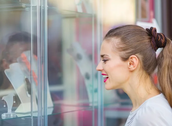Curious girl looking on showcase — Stock Photo, Image