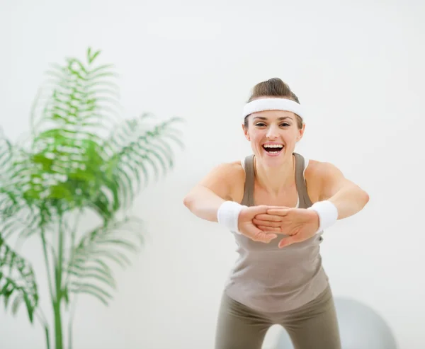 Smiling slim woman making stretching exercises — Stock Photo, Image