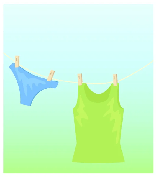 A woman hanging underwear on a clothesline - SuperStock