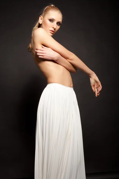 Semi naked blonde woman in long white skirt — Stock Photo, Image