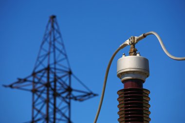 Electric insulator on the blue sky background clipart