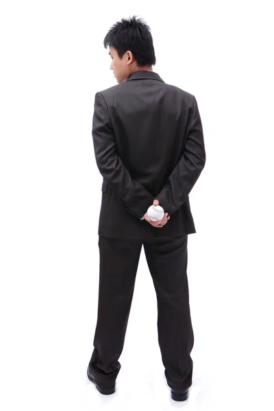 Business man holding ball in his back — Stock Photo, Image