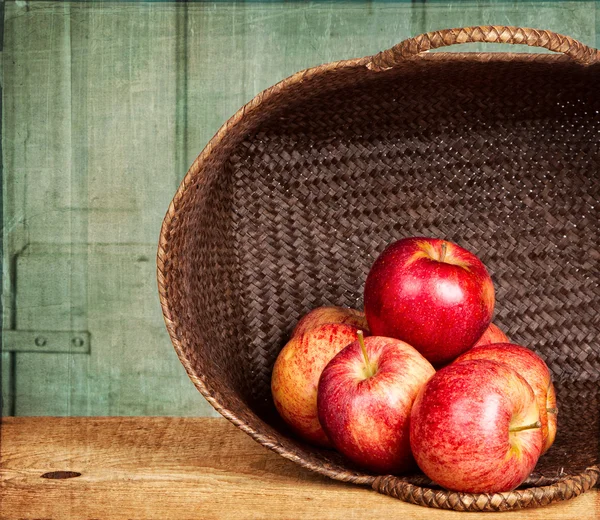 stock image Apples in basket on grunge background