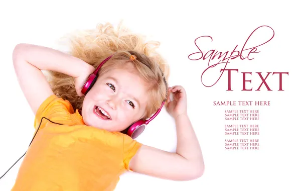 Young girl listening to music on headphones — Stock Photo, Image