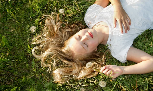 stock image Girl sleeping in a field of grass