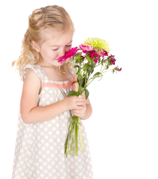 Little girl smelling flowers — Stock Photo, Image