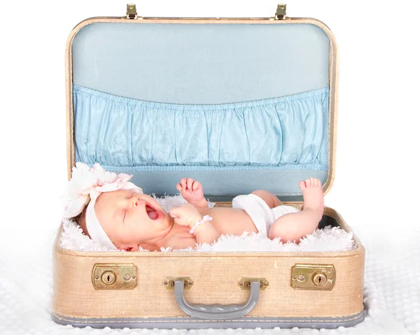 Baby yawning in a suitcase — Stock Photo, Image