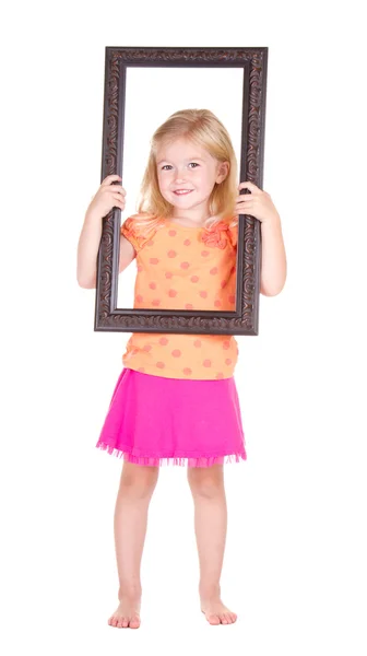 Criança segurando quadro em torno do rosto — Fotografia de Stock