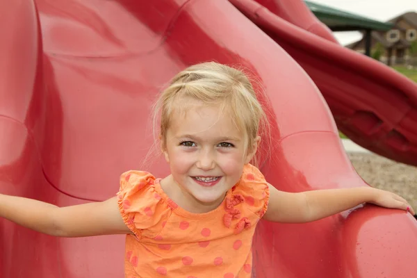 Little girl on slide — Stock Photo, Image