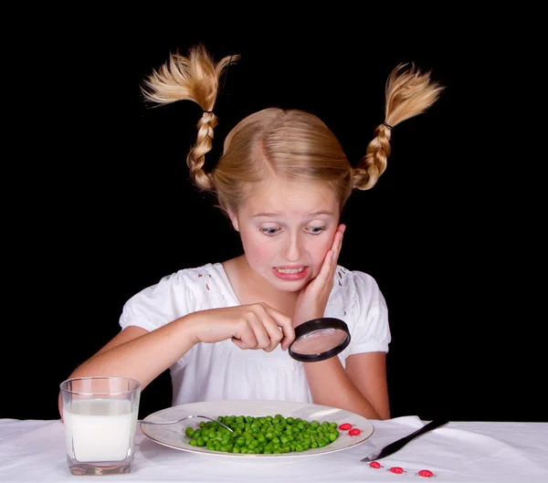 Girl examining bugs on table with magnifying glass — Stock Photo, Image