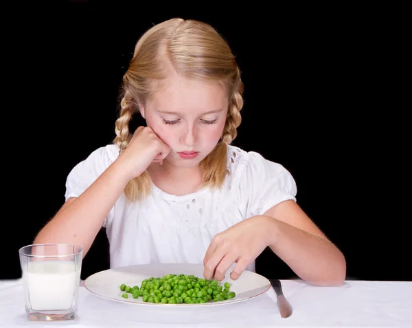 Child or teenager dislikes peas — Stock Photo, Image