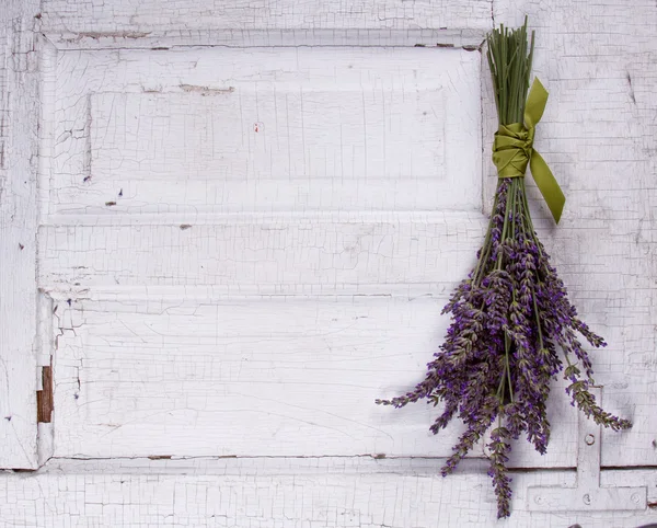 Lavender laying on an old door panel — Stock Photo, Image