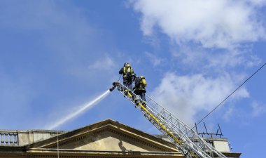 Fire engines at the scene of city fire clipart