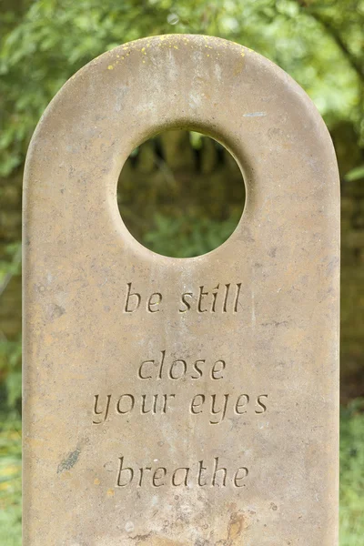 Gravestone with a circular hole — Stock Photo, Image