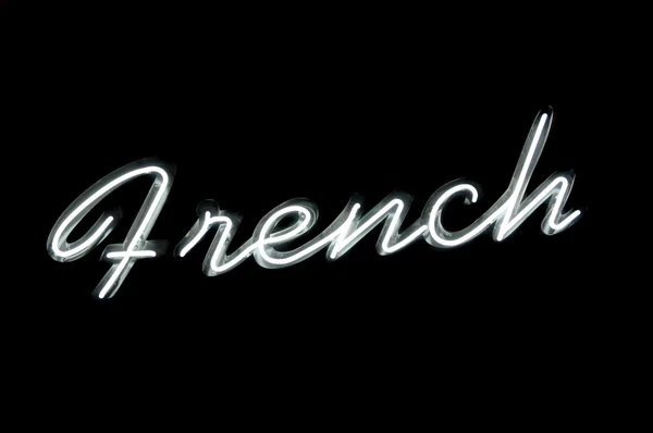 Panneau au néon avec le mot "français" sur noir — Photo