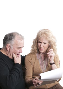 Older couple going over accounts clipart