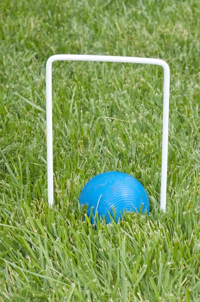 stock image Croquet ball sitting under a hoop