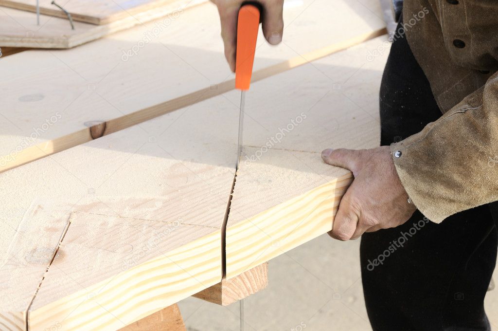 Carpenter checking teeth on saw