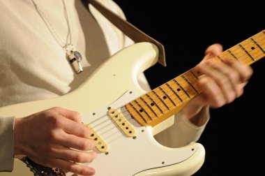 Closeup of guitarist playing in lve concert clipart