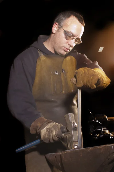Blacksmith working on decorative handrail — Stock Photo, Image
