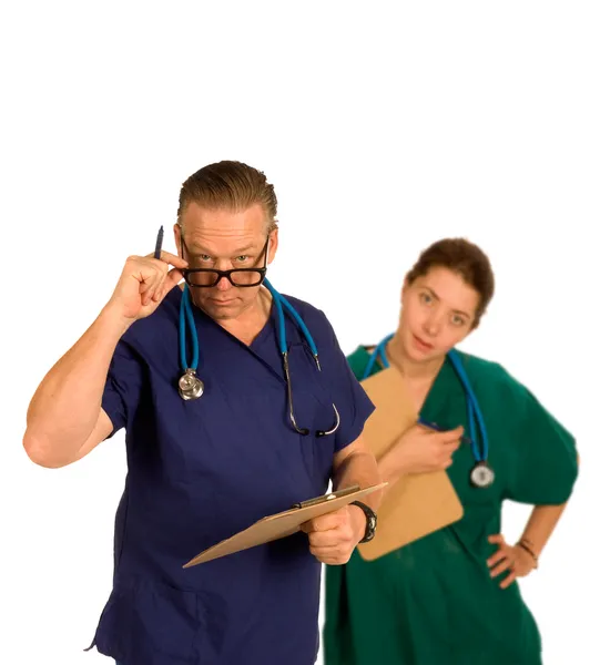 Doctor and intern checking chart — Stock Photo, Image