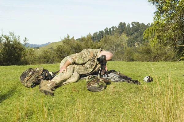 Hunter checking for game with spotting scope — Stock Photo, Image