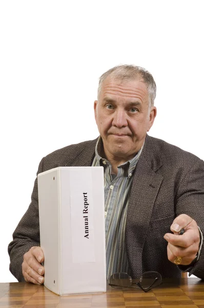 Baby-boomer businessman with annual report — Stock Photo, Image
