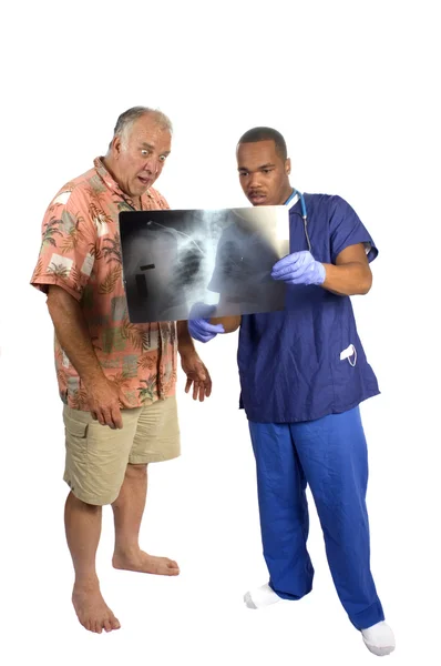 Arzt erklärt überraschtem Patienten Röntgenbild — Stockfoto