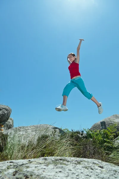 stock image Fitness girl jumping over boulders