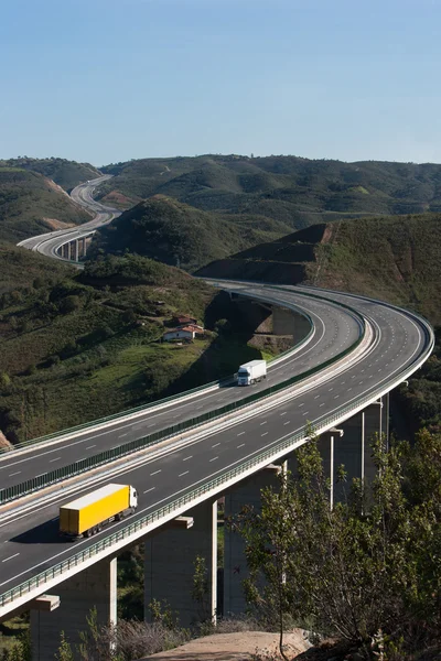 Aerial view of motorway with yellow and white trucks — Stock Photo, Image