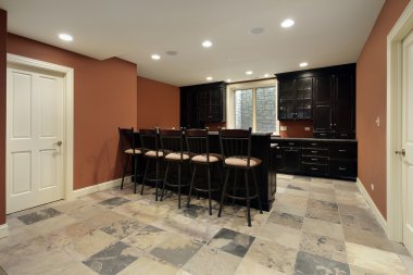 Bar in basement with dark wood cabinetry clipart