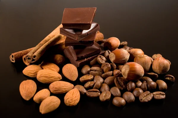 Chocolate, coffee , cinnamon and nuts — Stock Photo, Image