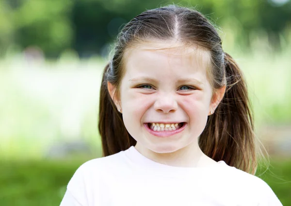 Młoda dziewczyna, śmiejąc się w parku — Zdjęcie stockowe