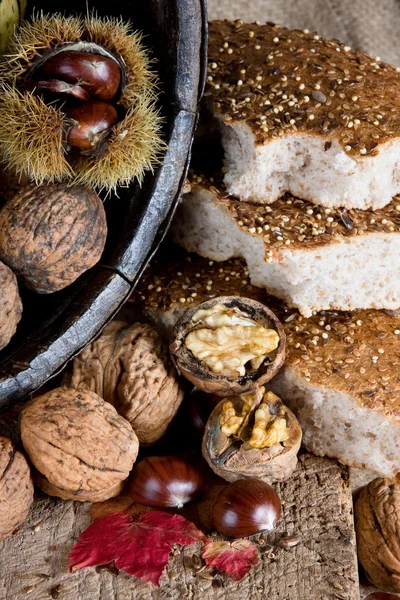 Nuts, chestnuts and bread — Stock Photo, Image