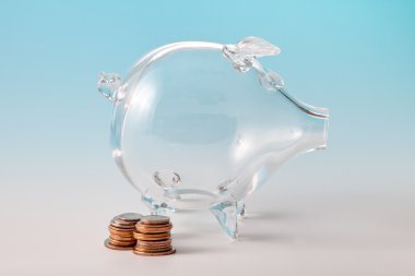 Glass piggy bank with coins clipart