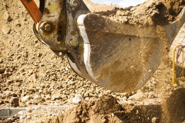 Wheel loader machine unloading sand at eathmoving works in const clipart