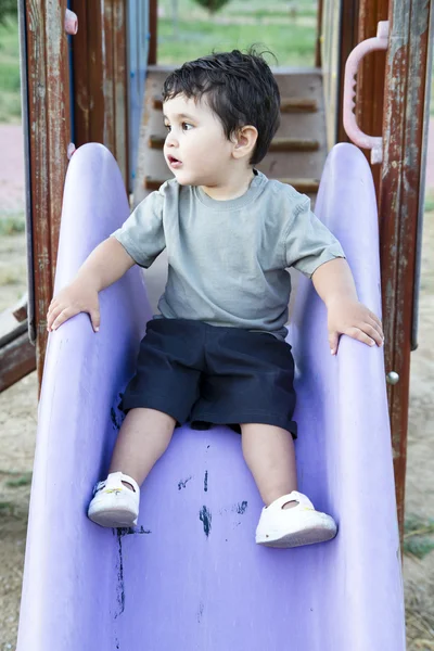 Kaukasiska pojke spelar på glidande styrelse — Stockfoto