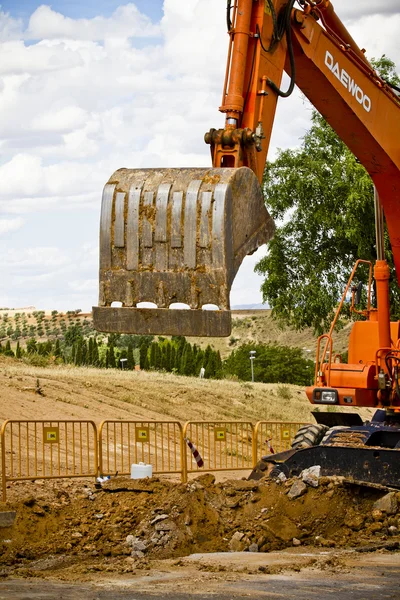 Primer plano skid steer loader excavadora en los trabajos de construcción de carreteras —  Fotos de Stock