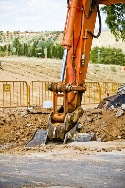Loader Excavator standing in sandpit with risen bucket over clou — Stock Photo, Image